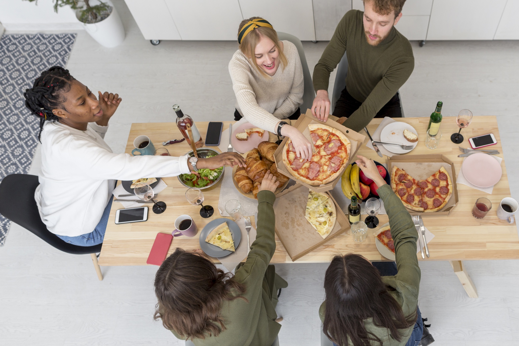 Family around a table sharing a meal prepared from a kit